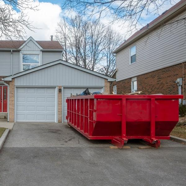 industrial-sized dumpster lifting construction waste